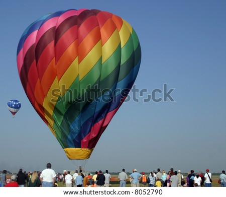 Crowd of people looking at hot air balloon. [faces not visible]
