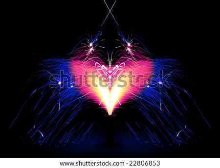 Fireworks giving off a shower of pink & blue sparks in the shape of a heart - Symmetry.