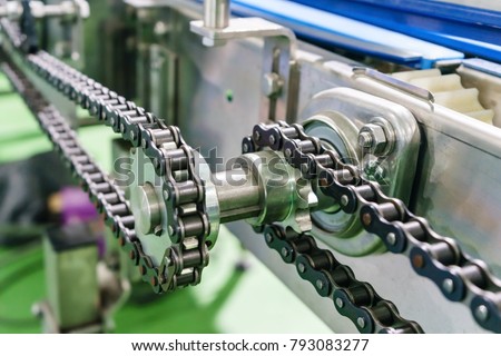 Gear and chain drive shaft in conveyor chain, and conveyor belt is on production line.
