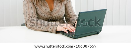 Woman in office with laptop