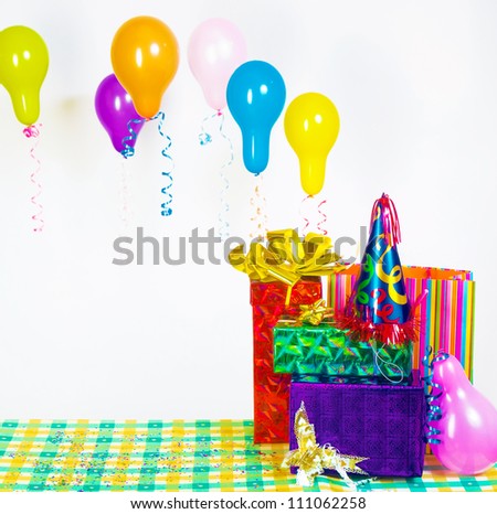 pile of gifts on the table and colorful balloons. The festive mood