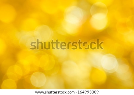Golden festive abstraction. Defocus highlights. yellow background