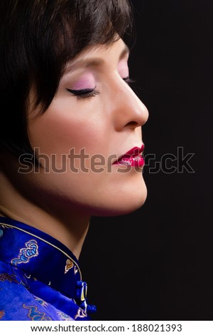 Beautiful young woman. Japanese makeup. Portrait on black background