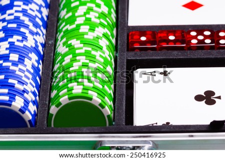 Chips, cards and dice in a suitcase. Set a game of cards