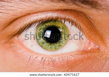 open green eye men. Close-up with bright light