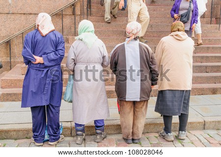 A line of old women, a traditional sight at most Eastern Orthodox churches, begging from worshipers at the Alexander Nevsky Cathedral in historic Tallinn, Estonia, a UNESCO World Heritage Site.