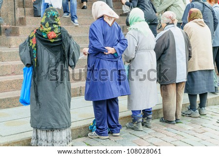 A line of old women, a traditional sight at most Eastern Orthodox churches, begging from worshipers at the Alexander Nevsky Cathedral in historic Tallinn, Estonia, a UNESCO World Heritage Site.