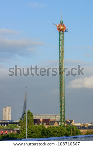 fairground fun fair in tivoli gardens in Copenhagen, Denmark, on a blue summer sky