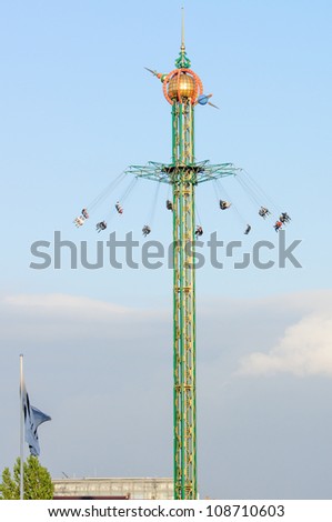 fairground fun fair in tivoli gardens in Copenhagen, Denmark, on a blue summer sky