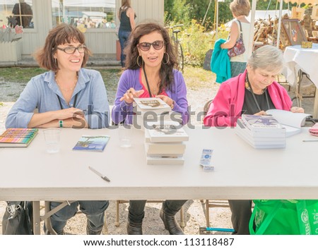 EDEN MILLS, ON - SEPTEMBER 16:  Canadian writers Nora Young, Carmen Aguirre and Michele Landsberg sign their books at the annual Writers Festival in Eden Mills, Ontario on September 16, 2012.