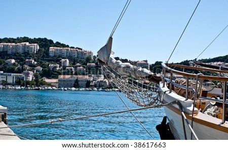 Sailing ship\'s bow with Dubrovnik in background