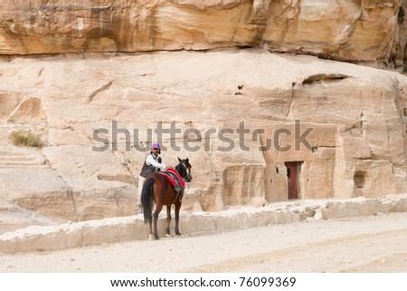 PETRA, JORDAN - NOV 24:  Unidentified Bedouin carriage rider on November 24, 2010 on way to ancient Petra, Jordan.  Petra is a UNESCO World Heritage Site since 1985.