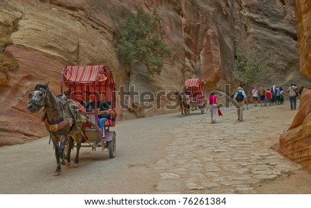 PETRA, JORDAN - NOV 24: Unidentified Bedouin carriage drivers take tourists into the ancient site on November 24, 2010 in Petra, Jordan. Petra is a UNESCO World Heritage Site since 1985.