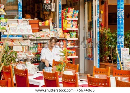 ISTANBUL, TURKEY - AUG 4: Unidentified man takes a siesta before his newspaper stand on August 4, 2009 in Istanbul, Turkey.Istanbul is the only metropolis in the world situated on two continents.