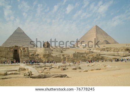 GIZA, EGYPT - NOV 15:  Tourists inspect the Pyramids and the Sphinx on November 15, 2010, at Giza, Egypt.  The world\'s oldest tourist attraction, the Pyramids of Giza are nearly 5000 years old.