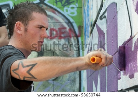 teenage boys tagging painting graffiti