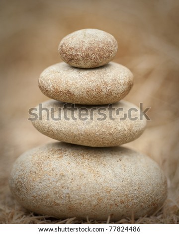 pile of rocks balanced against hay background