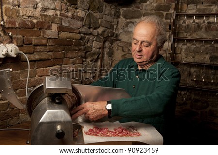 Italian man slicing salami