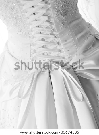 Close-up image of the detailed laces on the back of a wedding dress