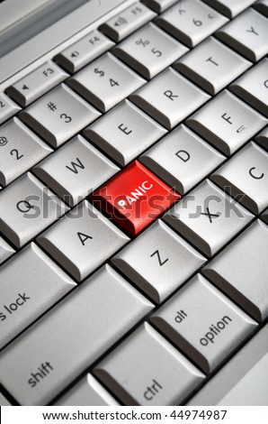 Close-up image of a red panic button on a traditional computer keyboard