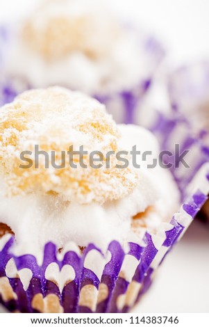 Freshly baked cup cakes with cream filling in cake trays