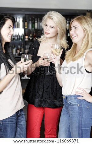 Beautiful young woman talking over coffee at a wine bar.