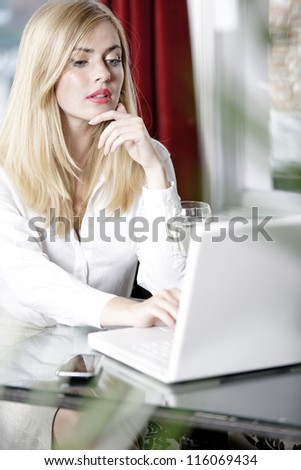 Attractive woman working on her laptop catching up after a long day.