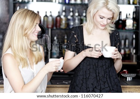 Beautiful young woman talking over coffee at a wine bar.