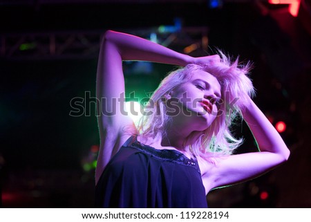 Attractive young woman dancing in a nightclub