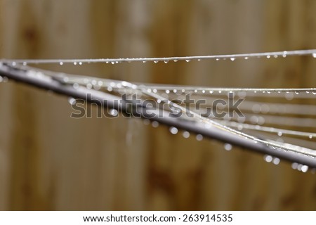 Glistening water drops on a rotary clothes line