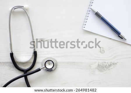 Still life of doctors medical stethoscope on a wooden surface