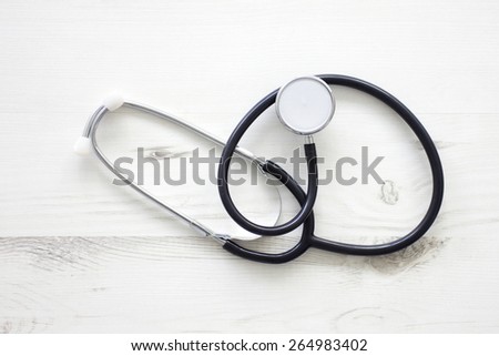 Still life of doctors stethoscope on wooden surface