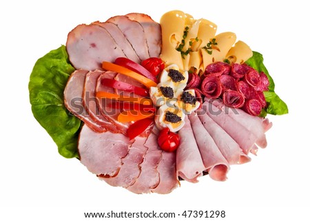 Dish with sliced ham, cheese and salami rolls, boiled eggs with black caviar and more.