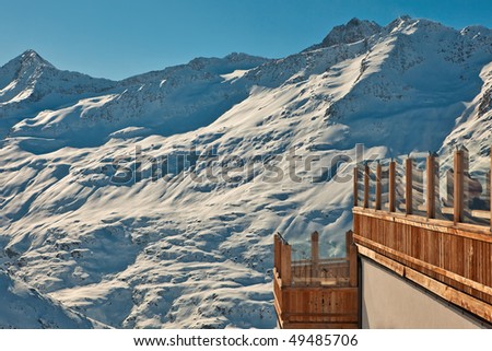 Mountain restaurant balcony view on high peaks in snow.