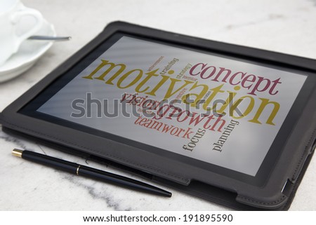 tablet with motivation word cloud