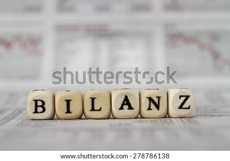 Balance word built with letter cubes on newspaper background