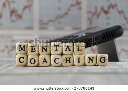 Mental coaching built with letter cube on newspaper background
