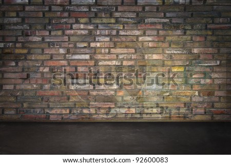 room with brick wall and dark floor