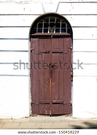Old wooden door covered with cracked, worn paint