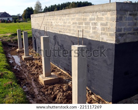 insulation against moisture foundation wall of the building made ??of concrete blocks for the clay soil