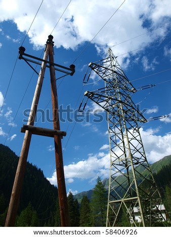 pole high and low voltage on a sunny day in mountainous terrain