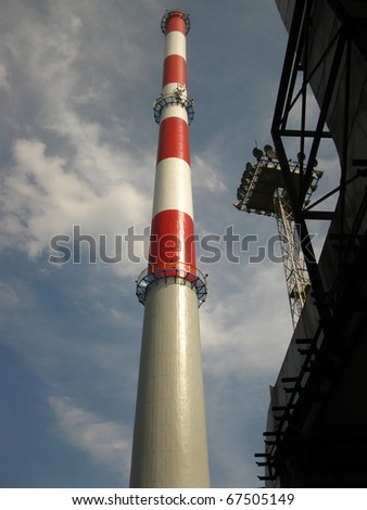 white, red and gray chimney against a blue sky