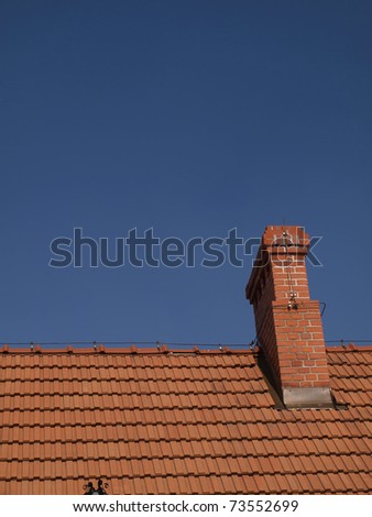 red-brick chimneys on the roof of red tiles