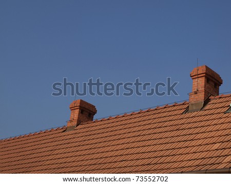 red-brick chimneys on the roof of red tiles