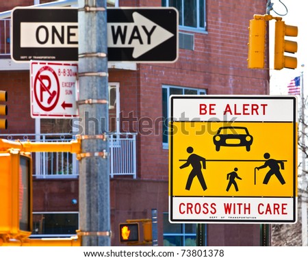 Warning sign at a dangerous, confusing and busy cross-walk.