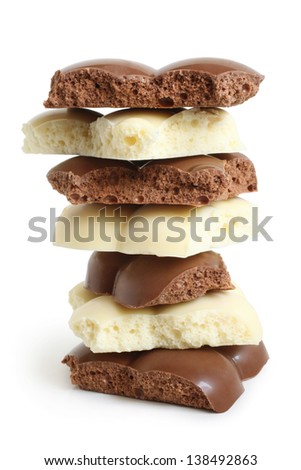 Stack of porous chocolate pieces on a white background