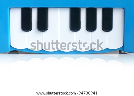 Blue child\'s piano on a white background