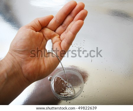 stock photo : quicksilver in the handful - real mercury metal