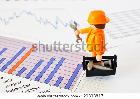 A little worker on a financial report