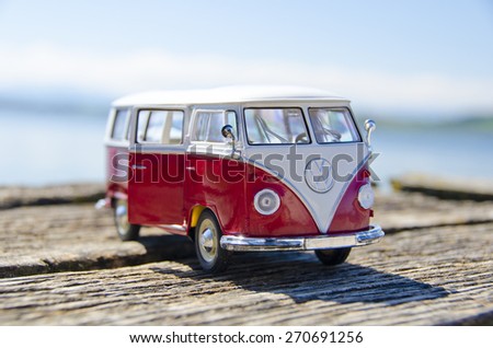 Miniature VW Bulli 1962 on the wooden pier. The cult car of the Hippie generation and it remained the status vehicle of the high wave surfers